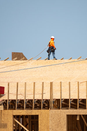 Wooden roof beam from framework. House roof at construction site. Roofer working on roof structure...