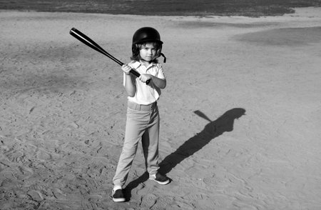 Boy kid posing with a baseball bat. Portrait of child playing baseball.の写真素材