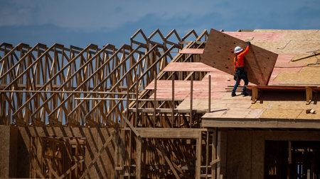 Wooden roof beam from framework. House roof at construction site. Roofer working on roof structure...