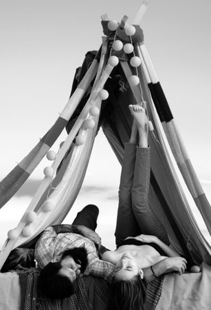 Romantic couple in tent camping on nature. Adventure for young friends relax in tent on summer day. Couples lovers camping in forest in summer time.の写真素材