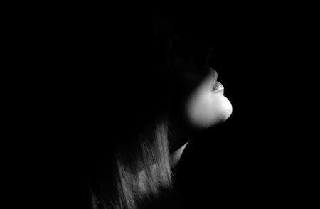 Fashion model with beauty face. Tender woman on black dark background. Tenderness concept. Tenderness womans look. Concept of beauty and tenderness lips.の写真素材