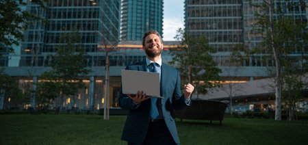 Happy smiling businessman in suit near office, successful employer to make a deal while standing...