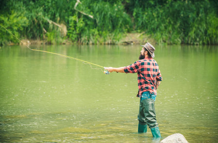 Fishing hobby and summer weekend. Bearded men fisher with fishing rod.