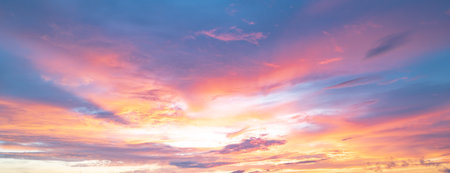 Sunrise background. Dramatic sunset background. Sky with clouds in Sunrise sky light background. Sunrise with clouds in various shapes background. Calm Sunrise.の写真素材