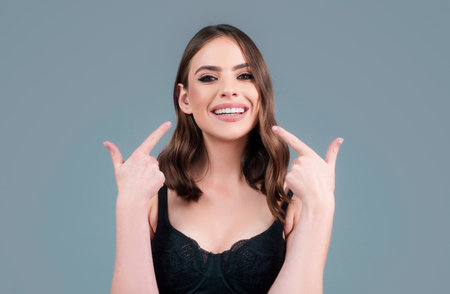 Laughing woman. Portrait of happy smiling girl. Cheerful young beautiful girl smiling laughing, studio isoalted background.の写真素材