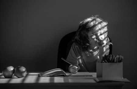 Little school kid boy doing homework at home. Child thinking, kids dream.の写真素材