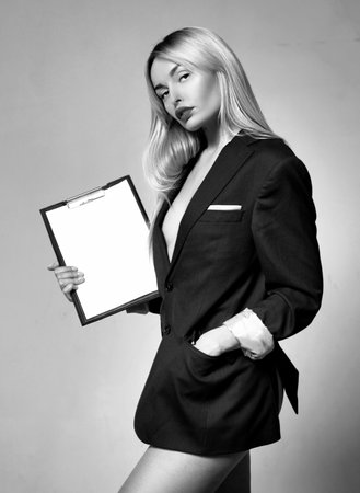 Fashionable businesswoman with notepad. Business presentation concept.の写真素材