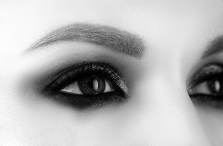 Closeup smoky makeup eye dark eyelids. Female eyes with beautiful bright fashion style.の写真素材