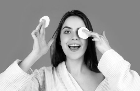 Beautiful young woman with clean fresh skin. Woman taking off makeup with cotton wipe sponge. Daily healthy beauty routine.の写真素材