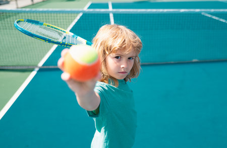 Kid boy at the tennis competition. Child practicing tennis forehand.の写真素材