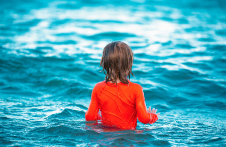 Happy child playing in the sea. Kid boy on the beach. Summer vacation and healthy kids concept.の写真素材