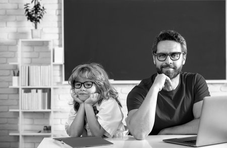 School pupil from elementary school with teacher in classroom.の写真素材