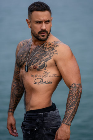 Sexy man posing outdoor on nature background. Man sexy. Handsome naked muscular man. Seductive guy. Hot boy. Sexy portrait of muscular handsome topless male model. Man with a naked torso.の写真素材