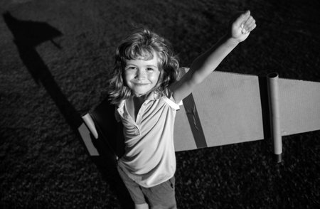 Excited kid superhero with jetpack. Child pilot play on summer day. Success, leader and winner...