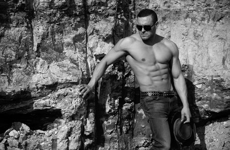 Sexy man body outdoor. Handsome muscular shirtless man in jeans outdoors. Strong sexy athlete. Sexy hunk.の写真素材
