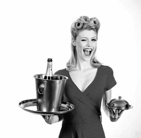 Pinup catering waiter with champagne and service tray. Restaurant serving presentation concept.の写真素材