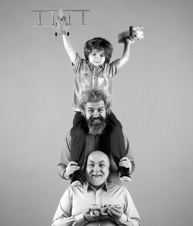 Kid having fun with toy plane. Men generation family with three different generations ages...