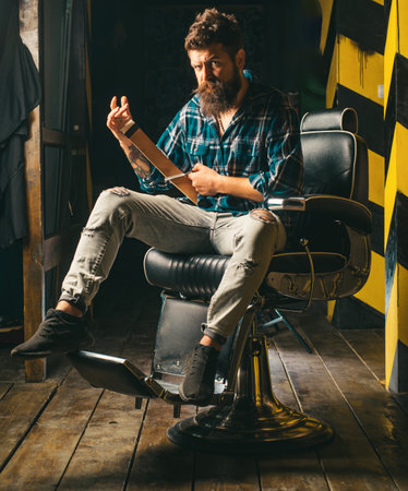 Hair style and hair stylist. Beard styling cut. Barber shop tools on old wooden background with copy space. Bearded man.の写真素材