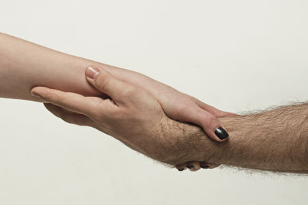 Helping hand. Holding hand, close up. Giving a helping hand. Rescue, helping gesture or hands. Salvation relations. Hand reaching out to help, relations. Rescue, helping gesture or hands.の写真素材