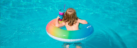 Kid with colorful swim ring in swimming pool on summer day. Water toys and floats for child. Healthy sport for children. Banner for header, copy space. Poster for web design.の写真素材