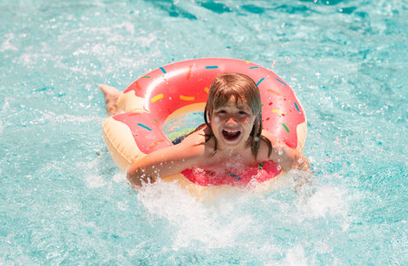 Child in swimming pool. Summer lifestyle. Swim water sport activity on summer vacation with kids....