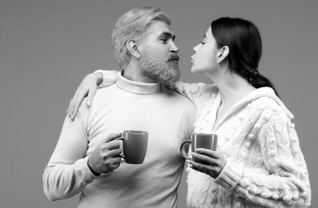 Happy cozy kiss couple at morning. Family enjoying usual evening together and having a romantic...