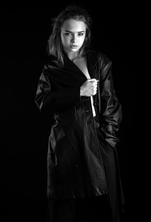 Woman leather fashion. Beautiful girl in black coat. Fashion trendy vogue style.の写真素材