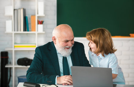 Teacher and child in classroom. Home education concept. School learning concept. Boy elementary...