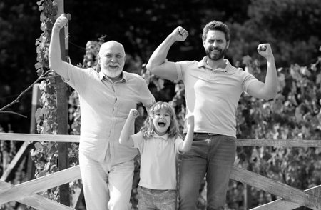 Multi generation family. Excited grandfather father and son outdoors. Three men generation. Happy...