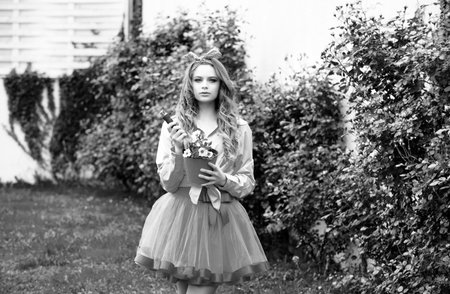 Teenager girl planting plants in the garden. Teen flovers gardening. Planting flowers.の写真素材