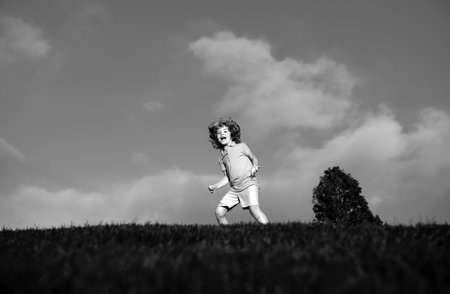 little boy having fun at the park. Kid enjoy nature, childhood concept.の写真素材