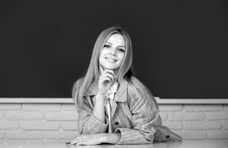 Female student on lesson lecture in classroom at high school or college. Positive emotions of cute school girl.の写真素材