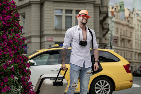 Man tourist with travel bag. Tourist man with travel bag travelling. Man with suitcase walk on city street outdoor. Traveling abroad on weekends.の写真素材