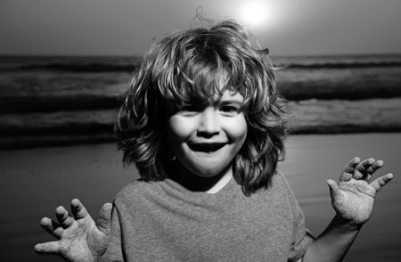Kid boy portrait on sunset beach, thumbs up. Amazed surprised kids emotions with fynny face.