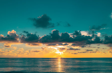 Sunset on tropical beach sea ocean with sunrise clouds. Banner for travel vacation. Cloudscape over...