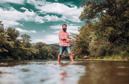 Fisherman using rod flyfishing in mountain river. A fly fisherman fishing for wild trout on the...
