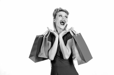 Happy pinup woman with shopping bags. Big sales. Pretty lady shopaholic.