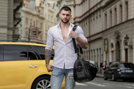 Portrait of fashion man with luggage, suitcases going on vacations. Travel lifestyle. Traveler man tourist traveling abroad to travel on weekends getaway.の写真素材
