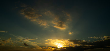 Dramatic Sky. Majestic sunlight. Night light reflected on clouds. Night Sun rays over panoramic...
