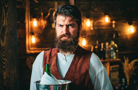 Bearded bartender or waiter in work uniform. Long bearded waiter or servant. Brutal bearded servant....