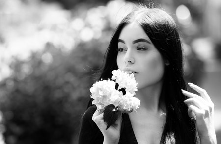 Portrait of beautiful model with make up outdoor. Beauty girl face. Woman with flowers.の写真素材