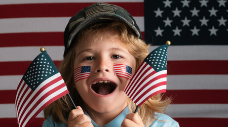 Kid celebration independence day 4th of july. United States of America concept. Child with american flag. Memorial day. Funny kids face with american flag on cheek. Usa fan.の写真素材
