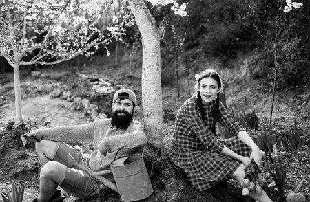 Smile Couple on farmland. Earth concept. Spring gardening routine. Summer farming. Eco farm.の写真素材