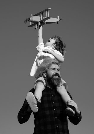 Fathers day. Happy father and son on meadow in summer. Family holiday and togetherness.の写真素材