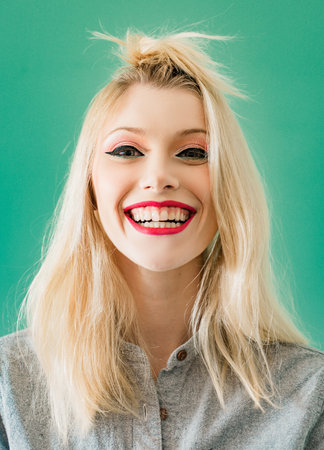 Funny beautiful sexy woman with funny hairstyle and glamorous make-up and hairstyle, on white...