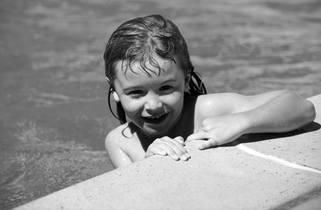 Portrait of child in summer swimming pool.
