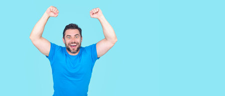 The winner. Successful man raising arms. Excited man with arms up celebrating success. Ecstatic excited male winner celebrating win. Overjoyed business man enjoy victory.の写真素材