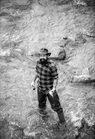 Fisherman caught a fish. Man fishing on river. Fisher man in water catching fish, top view.の写真素材