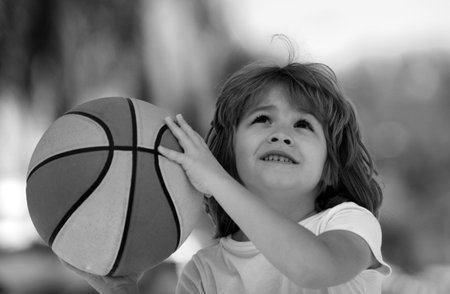 Child boy face preparing for basketball shooting. Best sport for kids.の写真素材