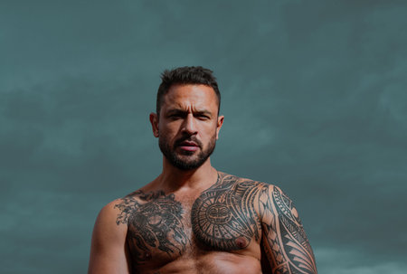 Sexy man. Outdoor male portrait on dramatic sky.の写真素材